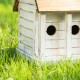 Glitzhome 14.25"L Oversized Washed White Distressed Solid Wood Cottage Birdhouse with Natural Wood Roof