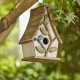 Glitzhome 9.5"H Washed White Distressed Solid Wood Decorative Outdoor Garden Birdhouse with Natural Wood Pallet Roof and 3D Tree