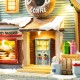 Glitzhome 10.25"H Lighted Christmas Donuts & Coffee Shop Resin Village with Movement and Music